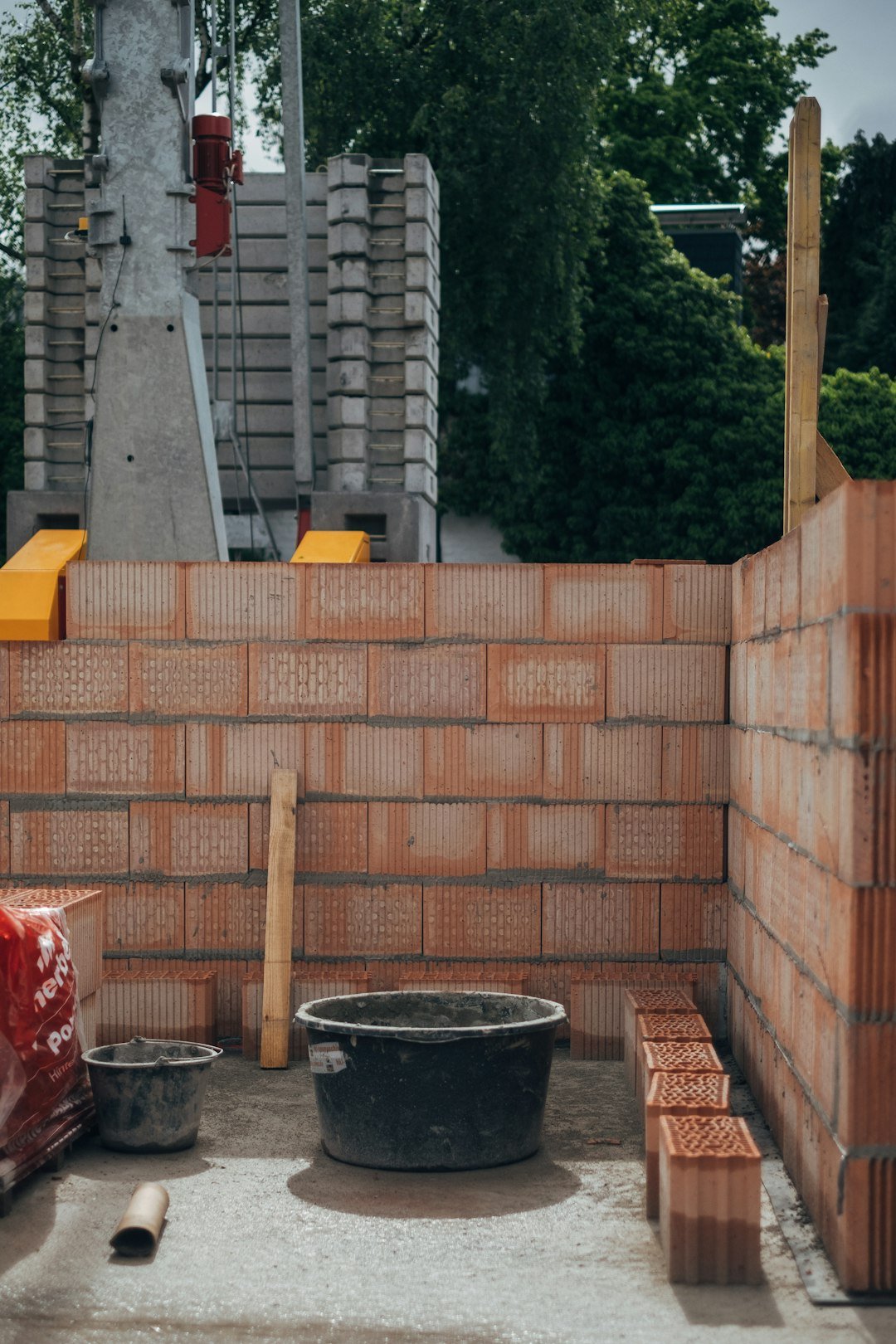 red-brick-wall-near-green-trees-during-daytime-0l1e0vqqhim